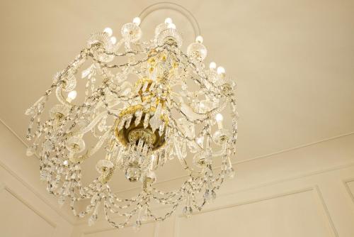 a chandelier hanging from a ceiling in a room at Grand Hotel Duchi d'Aosta in Trieste