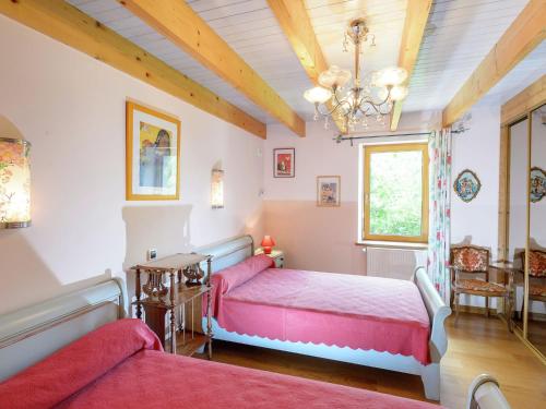 une chambre avec deux lits et un lustre dans l'établissement Chalet in Plounéour-Trez by Seaside Bay, à Plounéour-Trez