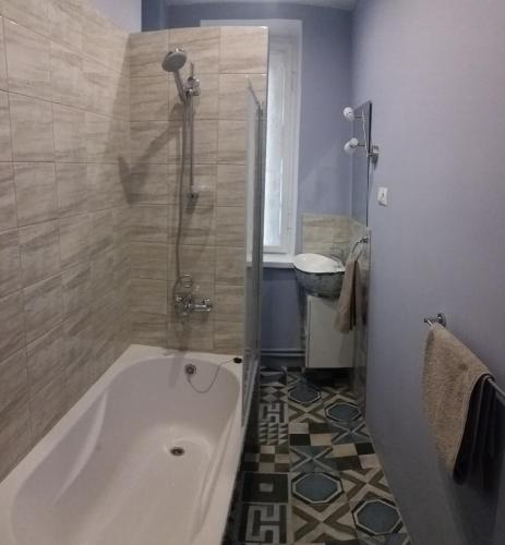 a bathroom with a tub and a shower and a sink at Apartment on Brivzemnieka in Liepāja