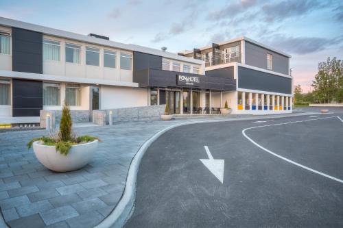 an empty parking lot in front of a building at Fosshotel Husavik in Húsavík