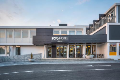 a front view of a building with a store at Fosshotel Husavik in Húsavík