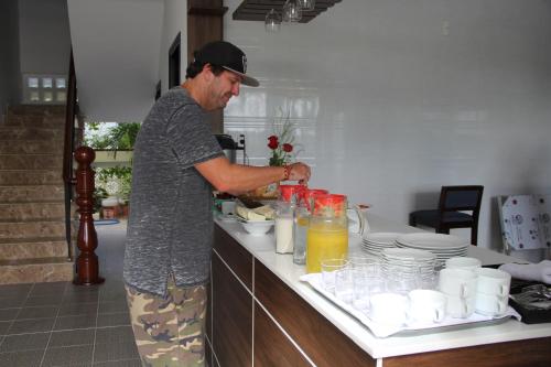 un hombre de pie en una cocina preparando comida en Hoi An Four Seasons Villa, en Hoi An