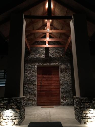a wooden door in a building with a wooden ceiling at MANZINI RIVER HOUSE - Mjejane Private Game Reserve, Greater Kruger National Park in Hectorspruit