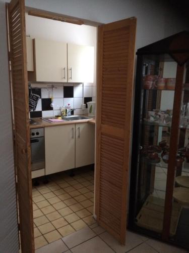 a kitchen with a door open to a kitchen with a sink at BASEMENT Links 108A 1 Zimmer Apartment in Holzminden