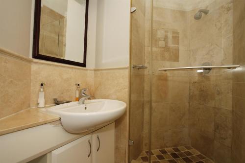 a bathroom with a sink and a shower at 503 Oyster Schelles in Durban