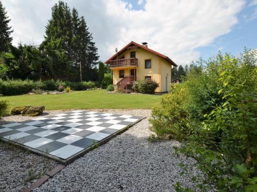 a house with a chess board in the yard at Country House in Czech Forest with Pool in Konstantinovy Lázně