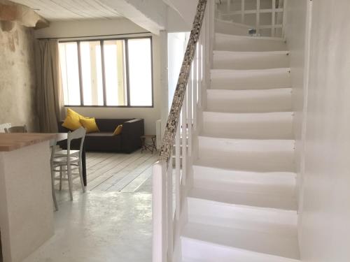 a staircase in a house with a living room at La petite maison d’à côté, au n°11 in Saint-Aignan