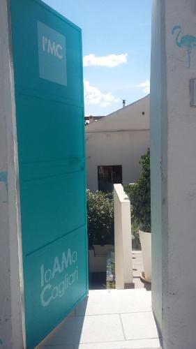 a blue sign in front of a building at I'MC IoAMoCagliari in Cagliari