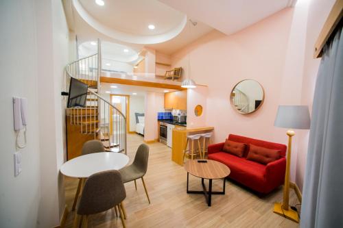 a living room with a red couch and a table at Apartments Madeira City Center in Funchal