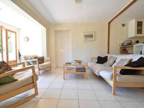 a living room with a couch and a table at Spacious vacation home with pool in Chaumard