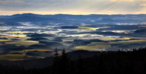 a view of a foggy valley with mountains in the background at Apartmány Pinie Lipno in Lipno nad Vltavou