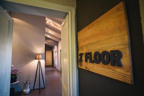 a hallway with a floor sign on the wall at Palazzo Gozzi Bed & Beauty in Parma