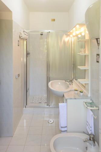 a bathroom with a shower and a sink and a toilet at La Casa dei Pini in Gubbio