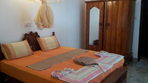 a bedroom with a bed with towels on it at Haus am Meer "Wilde Ananas" in Koggala