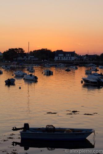 a group of boats in the water at sunset at Hotêl & Spa Du Parc Fétan in Larmor-Baden