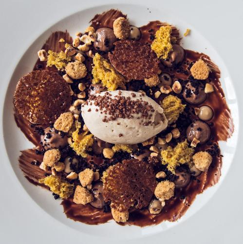 a plate of chocolate waffle with chocolate and nuts at Hotel Riviera dei Fiori in San Lorenzo al Mare