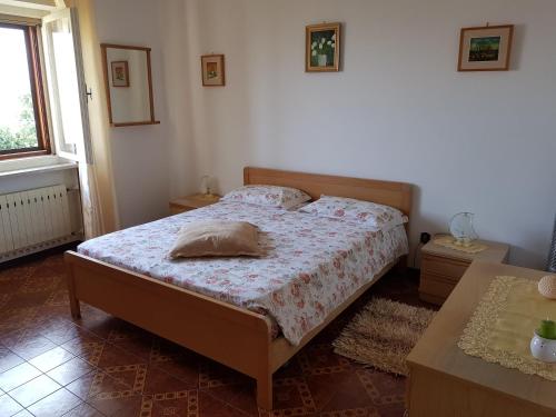 a bedroom with a bed with a pillow on it at Appartamento Nerio in Muggia