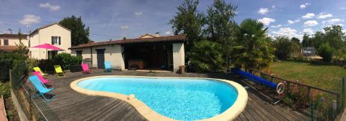 une piscine avec des chaises et une maison dans l'établissement Chambre d´hôtes La Jonchère, aux Herbiers