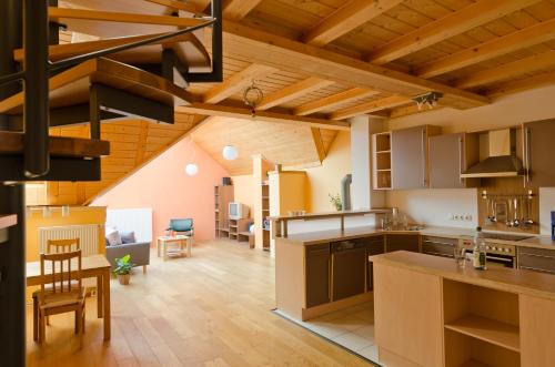 a kitchen and living room with wooden ceilings at Ferienwohnung Pforte 7 in Dalheim