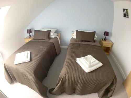 two beds in a room with two beds sidx sidx sidx sidx at Phoenix House Apartments in Walsall