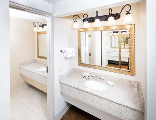 a bathroom with two sinks and a mirror at Red Lion Hotel Boise Downtowner in Boise