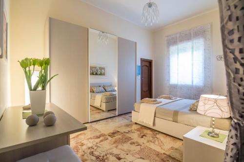 a bedroom with a bed and a large mirror at Villa Lazzari B&B Tra i due Mari in Maglie