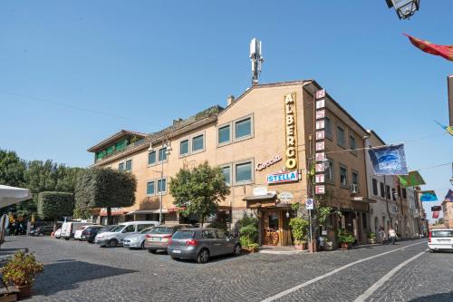 a street with cars parked in front of a building at Hotel Ristorante Stella in Palestrina