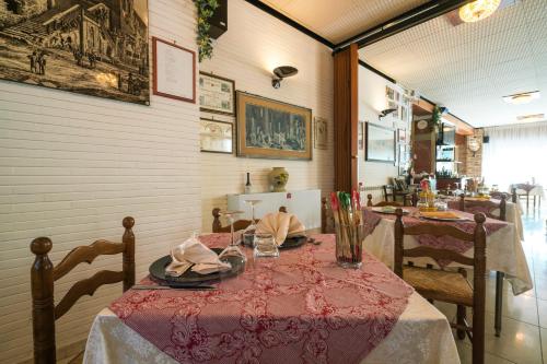 a dining room with a table with a red table cloth at Hotel Ristorante Stella in Palestrina