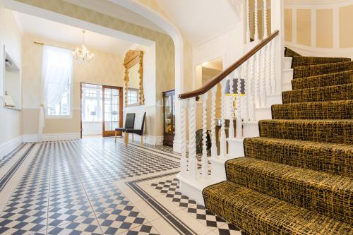 a staircase in a house with a checkered floor at Hotel Balmoral in Bournemouth