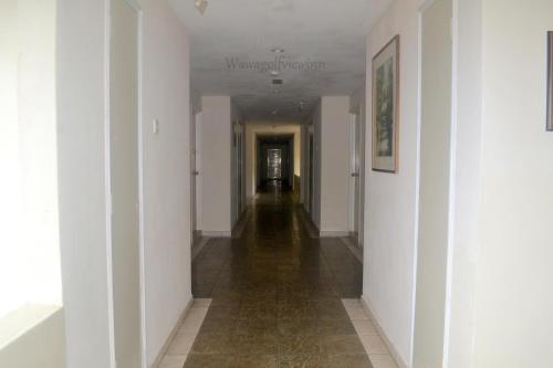 a long hallway with white walls and a long floor at Wawa's Golf View Inn in Taiping