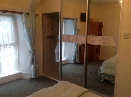 a mirror in a room with a bed and a bedroom at Sheehans On Main Street in Kenmare