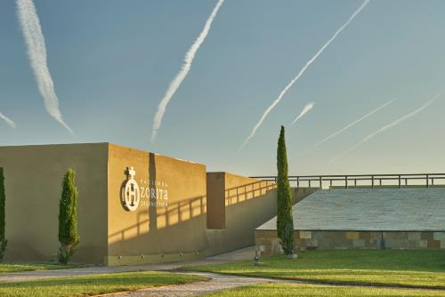 a building with a fountain in front of it at Hacienda Zorita Wine Hotel & Spa in Valverdón