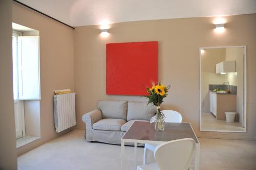 a living room with a couch and a table at Kalote' On The Roof Apartments in Noto