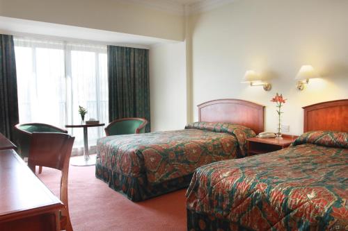 Postel nebo postele na pokoji v ubytování Grand Palace Hotel
