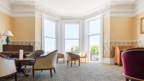 a waiting room with a table and chairs at Hotel Balmoral in Bournemouth