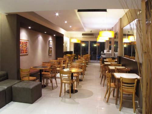 a restaurant with tables and chairs in a room at Hotel Milan in Buenos Aires