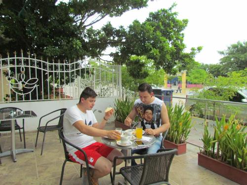 a group of three men sitting at a table at Hotel Diamonds in Ríohacha