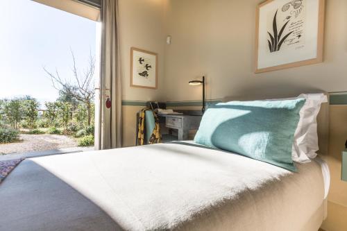a bedroom with a bed and a window at A440 in Tuscany in Pienza