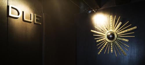 a clock on a wall with a light on it at Avogaria 5 Rooms in Venice