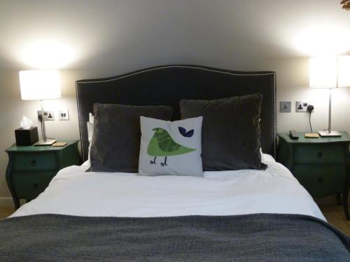 a bed with two pillows on it with two lamps at Edgar Townhouse in Bath