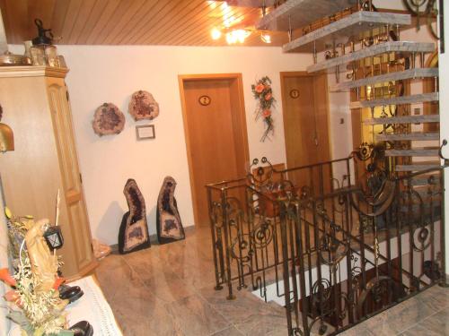 a room with a staircase and a bunch of shoes at Grubstuben in Schonach