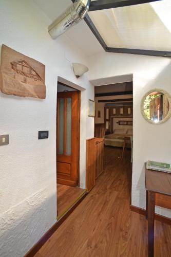 a living room with a table and a bedroom at B&B Il Torchio in Saint Vincent