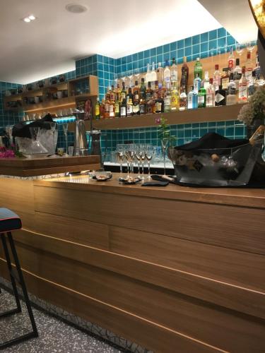a bar with glasses on the counter of a restaurant at 360Degrees Pop Art Hotel in Athens