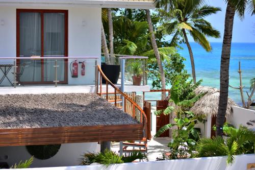 a house with a balcony overlooking the ocean at Veli Vilaa in Dhiffushi