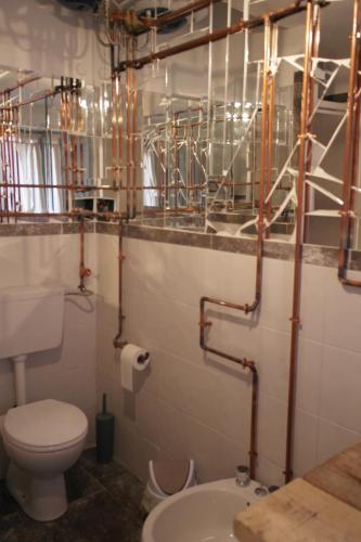 a bathroom with a toilet and a sink at My Eco Rooms Olbia in Olbia