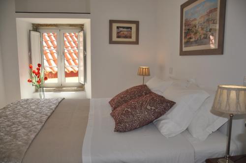- une chambre dotée d'un lit blanc avec un oreiller dans l'établissement Alfama Cozy Loft, à Lisbonne