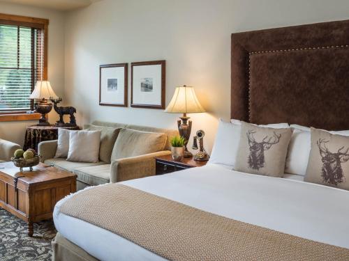 a hotel room with a bed and a couch at The Hotel Telluride in Telluride