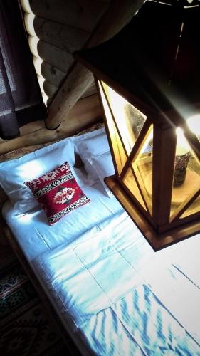 a bed in a room with a pillow on it at Apartments Greenstone in Kolašin