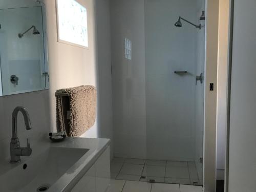 
a bathroom with a shower and a sink at Porkys Motel in Rockhampton
