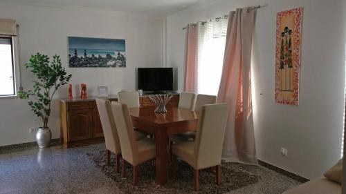 a dining room with a wooden table and chairs at Ericeira Beach Haven in Ericeira